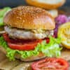 Delicious grilled chicken sandwich with lettuce, tomato, and sesame bun.