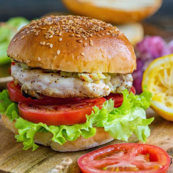 Delicious grilled chicken sandwich with lettuce, tomato, and sesame bun.